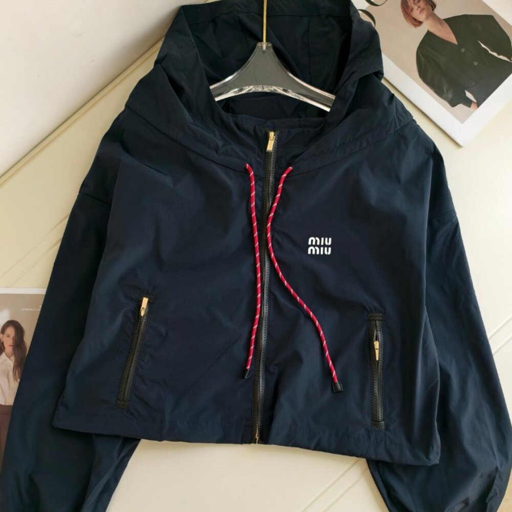 MIUMIU windbreaker, exquisitely tailored with a hood, combining workwear style w